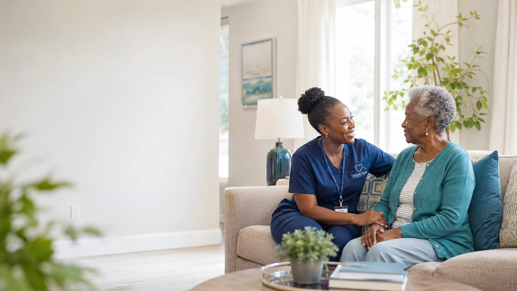 A caregiver sitting beside a senior client, providing companionship at home.